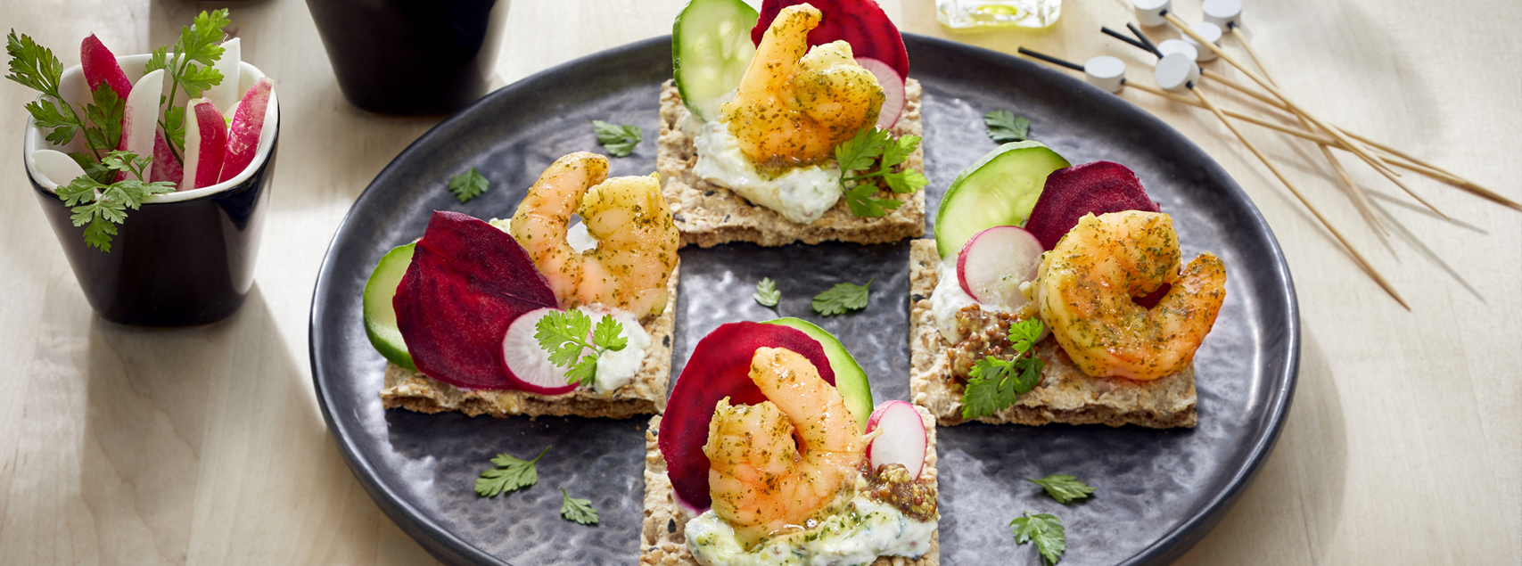 Canapés for aperitifs with organic marinated shrimps and crudities